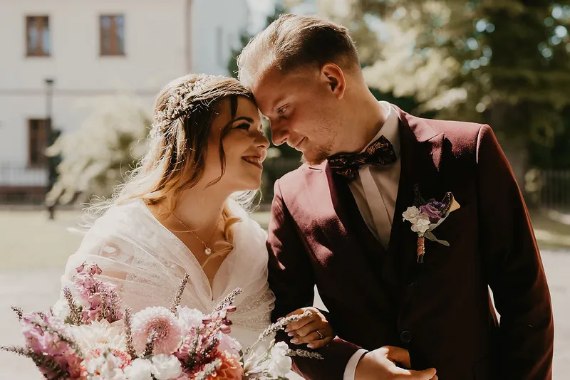 Para młoda z bukietem w słonecznym plenerze